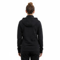 Back view of a woman wearing an Ashtown Clothing black polyester medical zip-up hoodie over matching scrub pants.