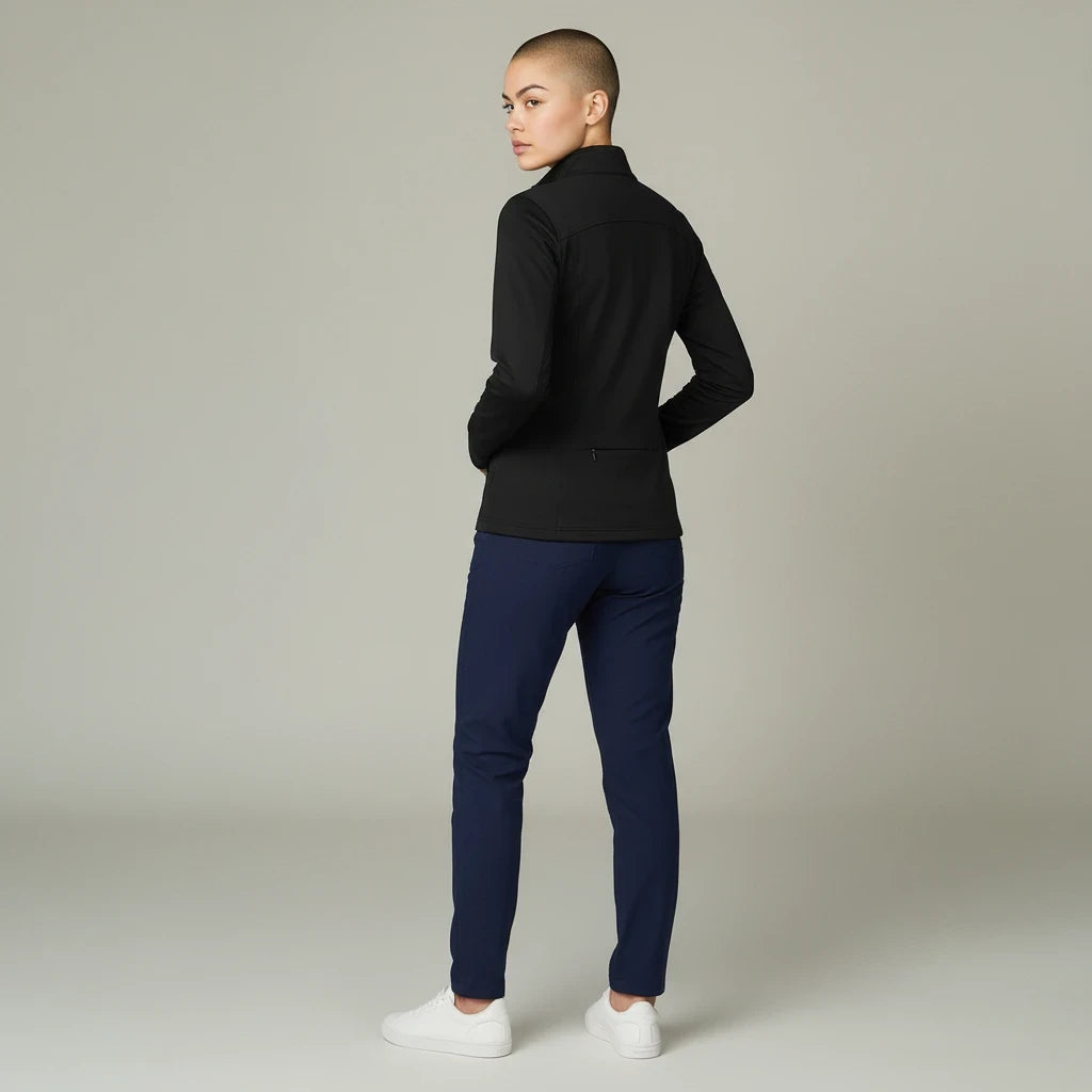 Ashtown Clothing women's black performance full zip medical jacket with back pocket, worn by a model from behind.
