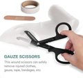 Ashtown Clothing black stainless steel medical trauma shears cutting through white gauze with tape and bandage nearby