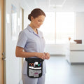 Ashtown Clothing black medical waist organizer pouch worn by a nurse in a hospital, featuring multiple tool pockets.
