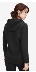 A woman wearing a black Ashtown Clothing performance full-zip hooded jacket, showing the back view.