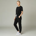 Ashtown Clothing women's black performance scrub joggers with ribbed cuffs and drawstring waist on a model.