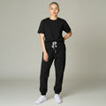 Ashtown Clothing women's black performance scrub jogger pants with a drawstring waist and ribbed cuffs on a model.