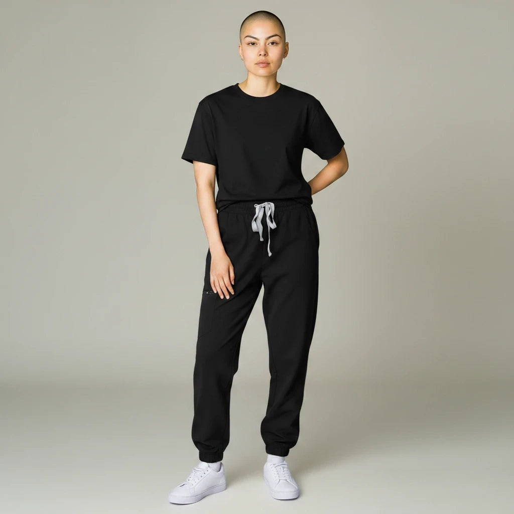 Ashtown Clothing women's black performance scrub jogger pants with a drawstring waist and ribbed cuffs on a model.