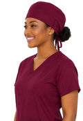 Ashtown Clothing burgundy medical scrub hat worn by a smiling healthcare professional in matching scrubs
