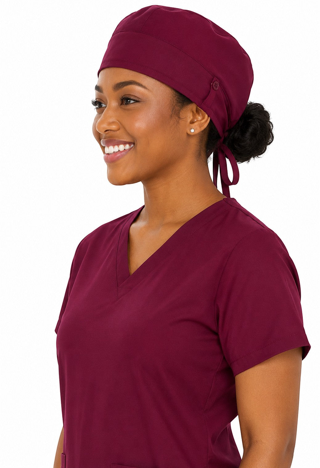 Ashtown Clothing burgundy medical scrub hat worn by a smiling healthcare professional in matching scrubs