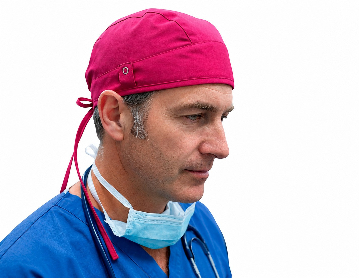 Ashtown Clothing fuchsia medical scrub hat worn by a male surgeon in blue scrubs against a white background