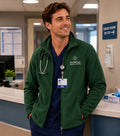 Ashtown Clothing forest green full zip fleece medical jacket worn by a male nurse in a hospital setting