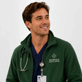Ashtown Clothing dark green fleece medical jacket with full zip and custom embroidery worn by a male healthcare worker
