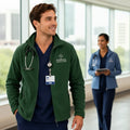 Ashtown Clothing dark green full zip fleece medical jacket worn by a male nurse with a stethoscope in a hospital