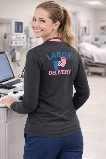 Ashtown Clothing charcoal grey long sleeve tee with Labor and Delivery baby footprint graphic worn by a nurse.