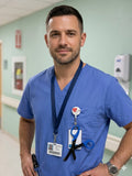 Ashtown Clothing male nurse in blue scrubs wearing black medical utility scissors with a retractable badge reel