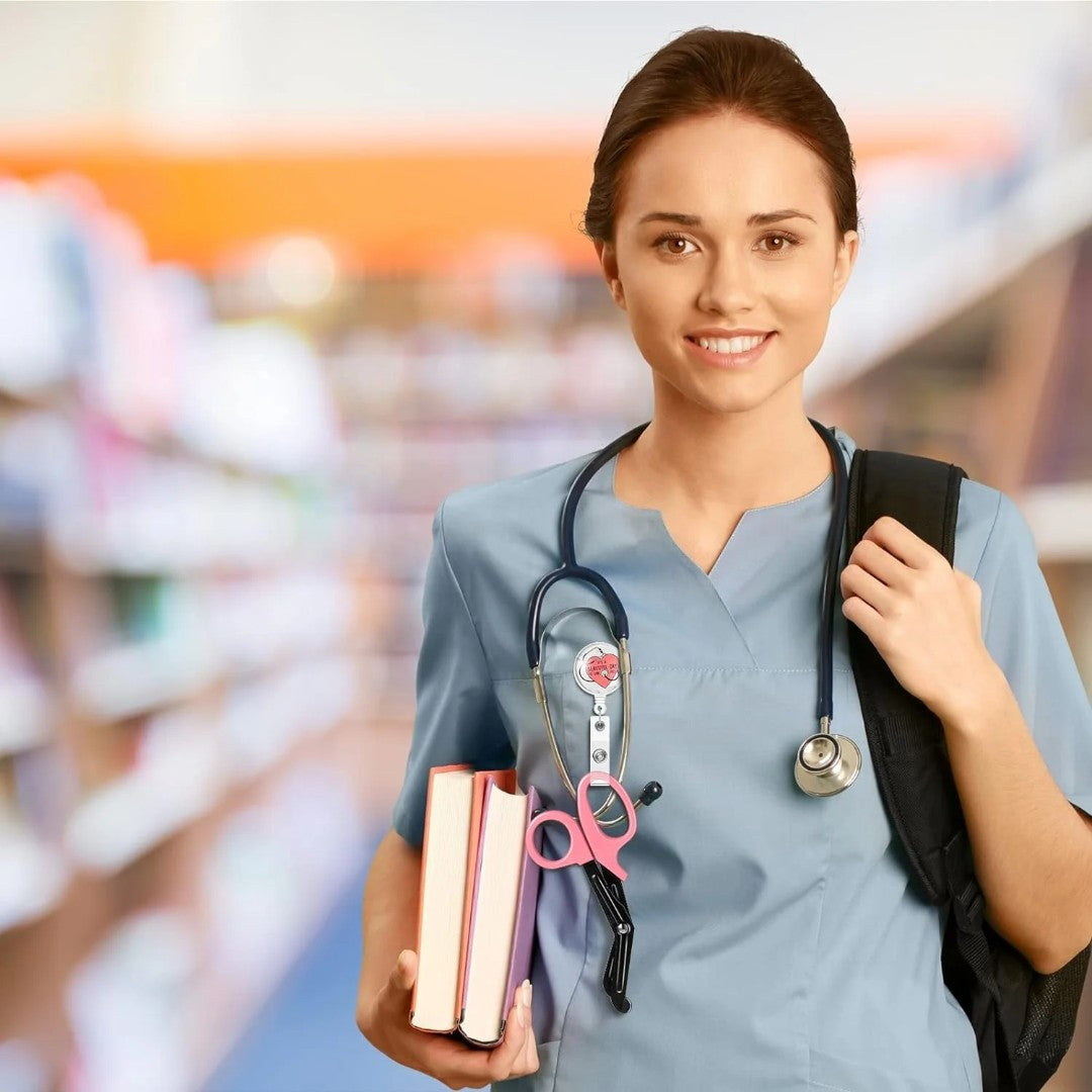 Ashtown Clothing medical student wearing blue scrubs with pink trauma shears and a retractable badge reel
