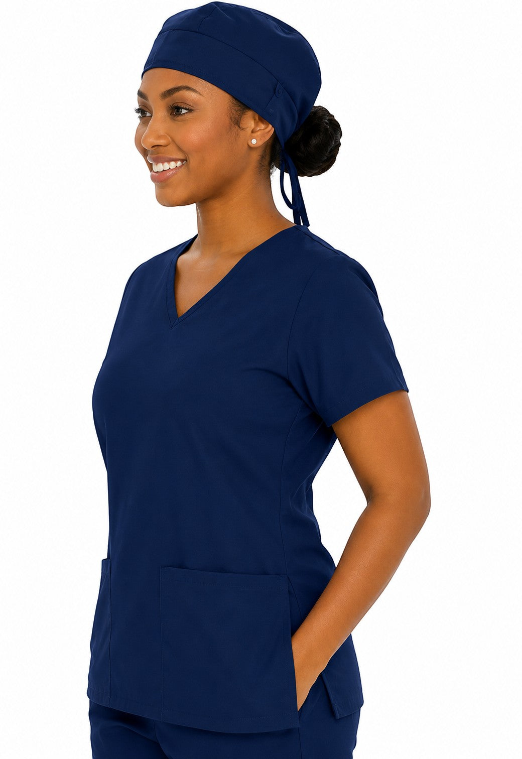 Ashtown Clothing navy blue medical scrub hat worn by a smiling healthcare professional in matching scrub top