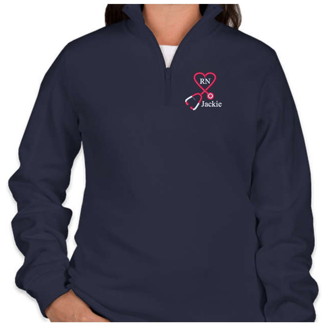Ashtown Clothing navy blue fleece quarter zip pullover featuring custom embroidered stethoscope heart and RN name