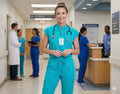 Ashtown Clothing teal mandarin collar scrub set with jogger pants worn by a smiling nurse in a hospital hallway.